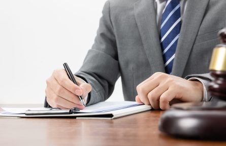 A closeup shot of a businessman signing some official papers