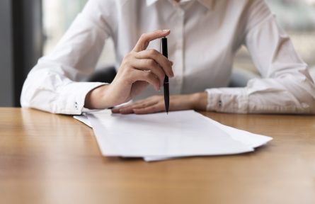 front-view-business-woman-clicking-pen