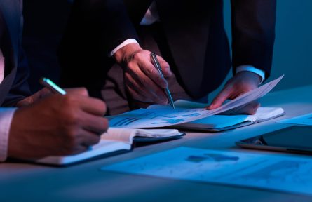 Close-up image of business partners working with financial documents