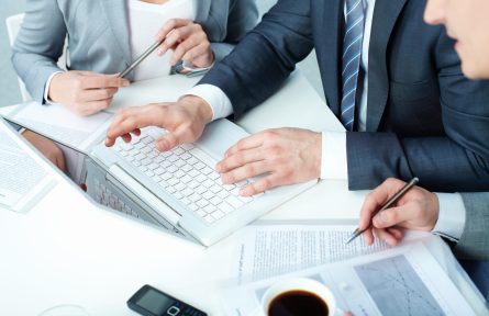 Group of business people working with laptop at meeting